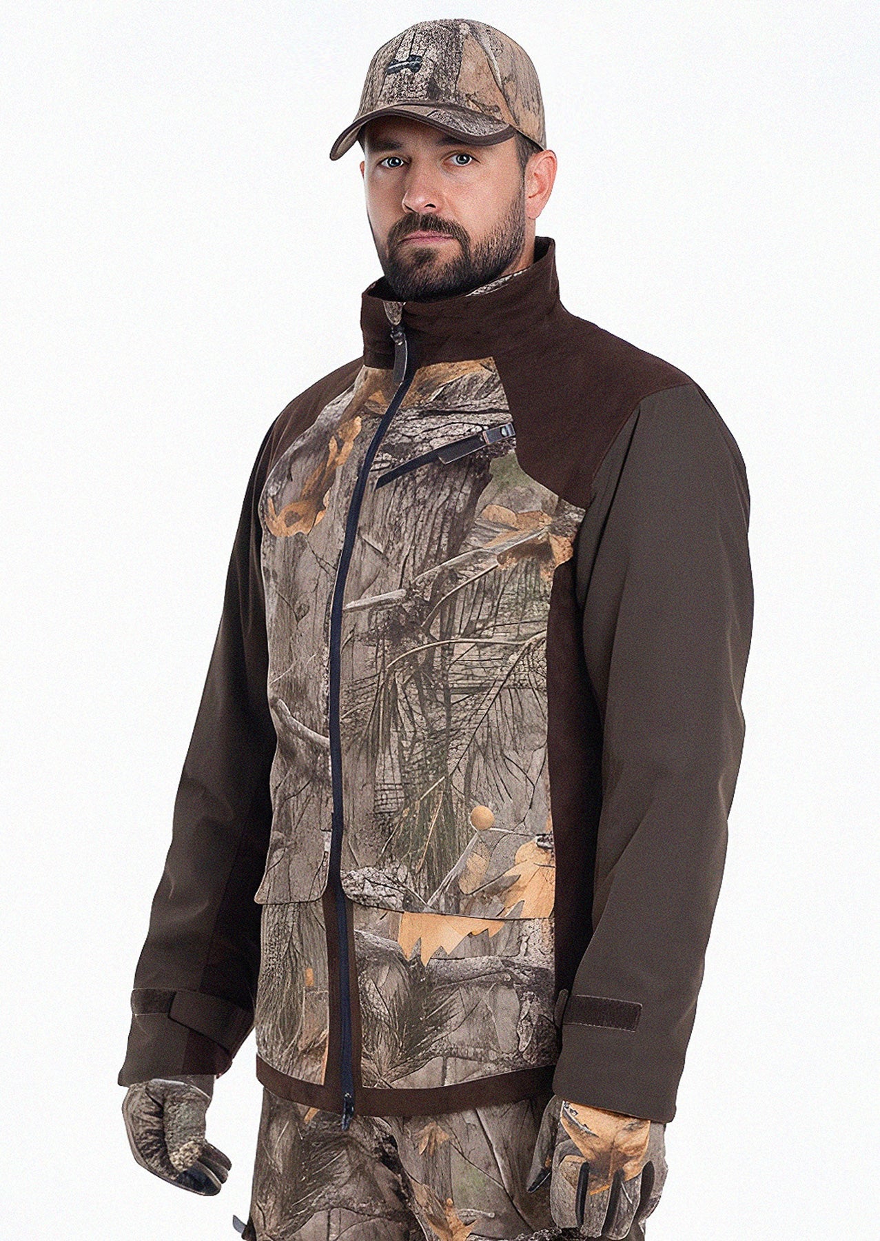 Ein bärtiger Mann trägt die Hillman Tarnjacke Jagd Camouflage - Fusion 3DX mit passender Hose, Mütze und Handschuhen und steht vor einem schlichten weißen Hintergrund.