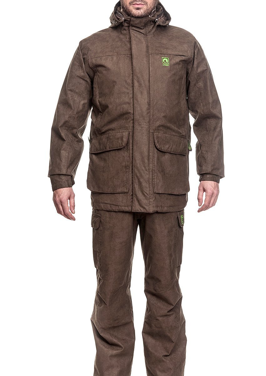 Eine Person, die die Argo® Jagdanzug ARGO® 3-in-1 Winter Jagdbekleidung für Herren in Braun mit zwei großen Fronttaschen und einem grünen Brustlogo, gepaart mit einer passenden Hose, trägt, steht vor einem weißen Hintergrund.